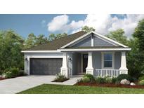 Charming single-story home with blue siding, a gray roof, a two-car garage and a manicured lawn at 3206 Lumber Falls Dr, Plant City, FL 33565