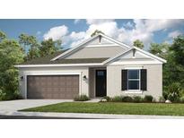 Charming one-story home featuring a gray exterior, attached garage, manicured lawn, and dark accents at 3404 Lumber Falls Dr, Plant City, FL 33565