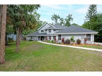 Charming two-story home with landscaped yard, lush green lawn and inviting walkway at 35 Deerpath Dr, Oldsmar, FL 34677