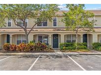Charming townhome with lush landscaping, a beautiful front door wreath, and reserved parking spaces at 4734 67Th N Ave, Pinellas Park, FL 33781