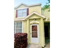 Charming townhome featuring an inviting front door with address and colorful landscaping at 6025 Osprey Lake Cir, Riverview, FL 33578