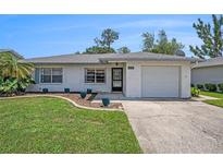 Charming single-story home with well-manicured lawn and attached one car garage at 6520 Meadowbrook Ln, New Port Richey, FL 34653