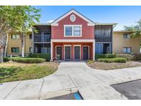 Inviting condo building with colorful facade, screened balconies, and neatly landscaped grounds at 10511 Waterview Ct # 10511, Tampa, FL 33615