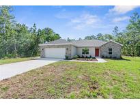 Charming single-story home featuring stone accents, fresh landscaping and a two-car garage at 16247 Little Auk Rd, Weeki Wachee, FL 34614
