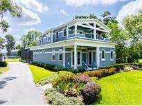 Charming two-story home with a manicured lawn and landscaped garden beds at 16603 Hutchison Rd, Odessa, FL 33556