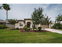 Charming single-story home features a well-manicured lawn and mature landscaping at 2143 Edelweiss Loop, Trinity, FL 34655