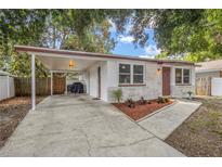 Charming single-story home with a carport, stone accents, and a well-manicured front yard at 2646 61St N Ave, St Petersburg, FL 33714