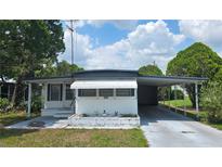 Charming single-story home featuring a carport and well-maintained yard at 37229 Lois Ave, Zephyrhills, FL 33542