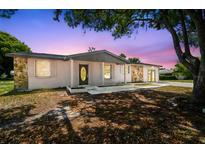 Charming single-story home featuring a unique stone accent wall and a well-maintained front yard, creating curb appeal at 4608 Deltona Blvd, Spring Hill, FL 34606