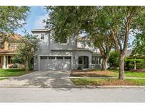 Charming two-story home featuring a two-car garage and mature landscaping at 7412 Bridgeview Dr, Wesley Chapel, FL 33545