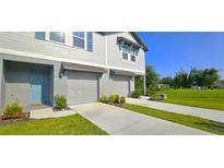 Charming two-story home with a manicured lawn, inviting curb appeal and attached two-car garage at 17015 Coral Key Dr, Nokomis, FL 34275