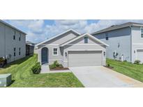 Charming single-story home featuring a two-car garage and well-maintained front lawn at 33922 Jasper Stone Dr, Wesley Chapel, FL 33543