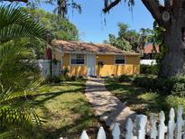 Charming single-story home with brick walkway, well-manicured lawn, and mature landscaping at 345 21St S Ave, St Petersburg, FL 33705