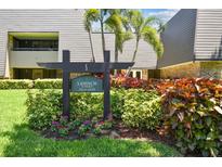 Lahinch Lodges features lush landscaping around building number five with palm trees and colorful flowers at 36750 Us 19 N # 08204, Palm Harbor, FL 34684