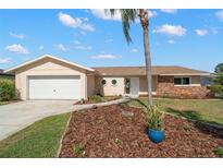 Charming single-story home with tan exterior, brick accents, and a well-maintained landscaped front yard at 3932 Shore Acres Ne Blvd, St Petersburg, FL 33703