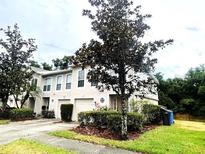 Charming townhome exterior with well-maintained landscaping and attached one car garage at 4617 Ashburn Square Dr, Tampa, FL 33610