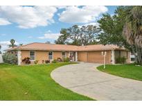 Charming single-story home with a well-manicured lawn and a long, winding driveway at 14564 110Th Ter, Largo, FL 33774