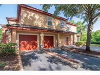 Charming townhome with two-car garage, manicured landscaping, and mature shade trees at 2173 Tuscany Trce # 8, Palm Harbor, FL 34683