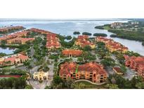 Beautiful aerial view of a waterfront condo community with lush landscaping and stunning water views at 2705 Via Murano # 127, Clearwater, FL 33764