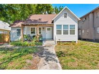 Charming single-Gathering home featuring a cozy front porch with seating and a well-maintained yard at 2911 N Jefferson St, Tampa, FL 33602