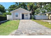 Charming single-story home with a neatly paved driveway and well-maintained lawn at 3615 W Cherry St, Tampa, FL 33607
