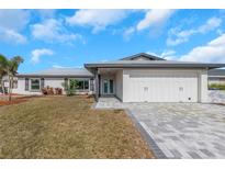 Charming single-story home featuring a two-car garage and a neatly manicured lawn at 6508 Senegal Palm Way, Apollo Beach, FL 33572