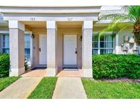 Inviting townhouse with two front doors, lovely landscaping and private entrance for each unit at 727 Kensington Lake Cir, Brandon, FL 33511