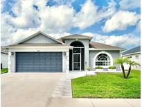 Charming single Gathering home with a two-car garage, front yard, and well-maintained landscaping at 10811 Lakeside Vista Dr, Riverview, FL 33569