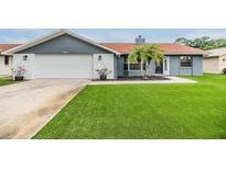 Charming single-story home features a well-manicured lawn and an attached garage at 10954 96Th St, Largo, FL 33773