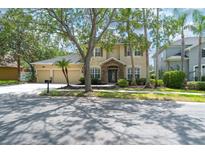 Charming two-story home featuring a three-car garage and meticulously landscaped front yard at 16170 Colchester Palms Dr, Tampa, FL 33647
