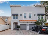 Charming two-story home with a red tiled roof, gray siding, and a two-car garage at 215 S Westland Ave # 3, Tampa, FL 33606