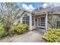 Charming home featuring a well-manicured front yard with beautiful landscaping and a welcoming entrance at 2355 Bentley Dr, Palm Harbor, FL 34684
