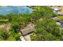 Stunning aerial view of a cozy home surrounded by mature trees and overlooking a tranquil lake at 525 Gornto Lake Rd, Brandon, FL 33510