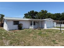 Charming single-story home with a well-maintained lawn and inviting front porch at 7021 Mayfield Dr, Port Richey, FL 34668
