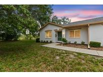 Charming single-story home with a well-maintained lawn and lush green landscape at 8175 Sturbridge # 8175, Weeki Wachee, FL 34613