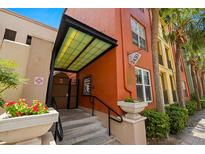 Charming entrance with colorful accents, a protective awning, and well-maintained landscaping creating an inviting welcome at 2410 W Azeele St # 214, Tampa, FL 33609
