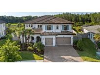 Beautiful two-story home featuring a tile roof, manicured lawn and a two car garage at 28512 Picana Ln, Wesley Chapel, FL 33543