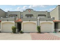 Charming townhouse with a two-car garage, elegant tile roof, and nicely manicured landscaping at 2914 W Gandy Blvd # C, Tampa, FL 33611