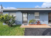 Charming exterior view with a freshly painted blue exterior and well-maintained landscaping at 3404 Dahlia Pl, Largo, FL 33771