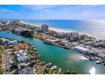 Beautiful aerial view of the beach, water, and condos with ample parking and canals nearby at 4103 Gulf Blvd # 210, St Pete Beach, FL 33706