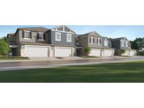 Attractive townhome featuring a private garage and a well-manicured lawn and inviting curb appeal at 9332 Cannon Beach Dr, Parrish, FL 34219