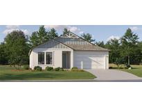 Charming single-story home featuring a two-car garage, well-manicured lawn and inviting neutral color palette at 9456 Gladsome Dr, Land O Lakes, FL 34637