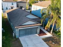 Charming single-Gathering home featuring a two-car garage, driveway, and lush landscaping at 12720 Hampton Hill Dr, Riverview, FL 33578