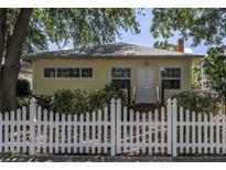 Charming single-story home featuring a welcoming entrance and a classic white picket fence at 2710 10Th N St, St Petersburg, FL 33702
