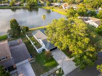 Gorgeous aerial view of single Gathering home on a pond with mature trees and paver driveway at 3925 Dunaire Dr, Valrico, FL 33596