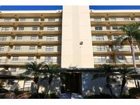 Beautiful condominium building with lush tropical landscaping and a grand entrance at 800 Cove Cay Dr # 4F, Clearwater, FL 33760