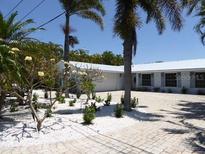 Charming single-story home with lush tropical landscaping and a brick driveway at 12055 4Th E St, Treasure Island, FL 33706