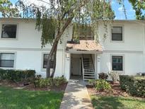 Charming two-story condo with well-maintained landscaping and inviting entrance at 303 Meadow Ln, Oldsmar, FL 34677