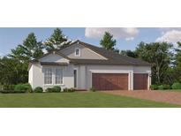 Charming single-story home with a 2-car garage, brick driveway, and lush green lawn at 31483 Cardinal Yard Dr, San Antonio, FL 33576