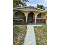 Inviting single-story home with a secure front door, arched supports, and a tidy front yard at 3505 E 38Th Ave, Tampa, FL 33610